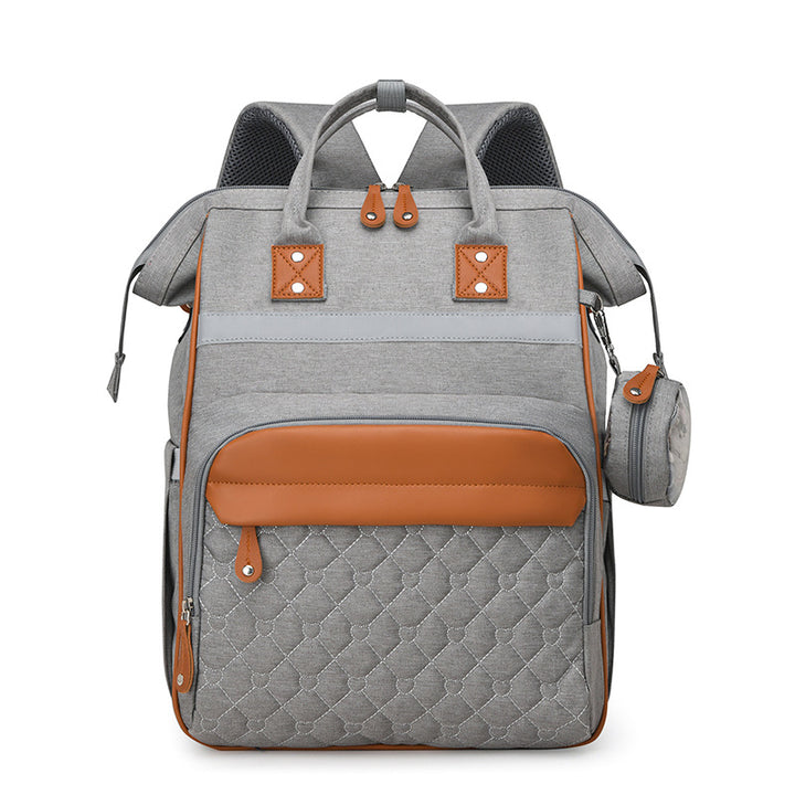 Sac à dos à langer matelassé gris clair bandes cuir caramel